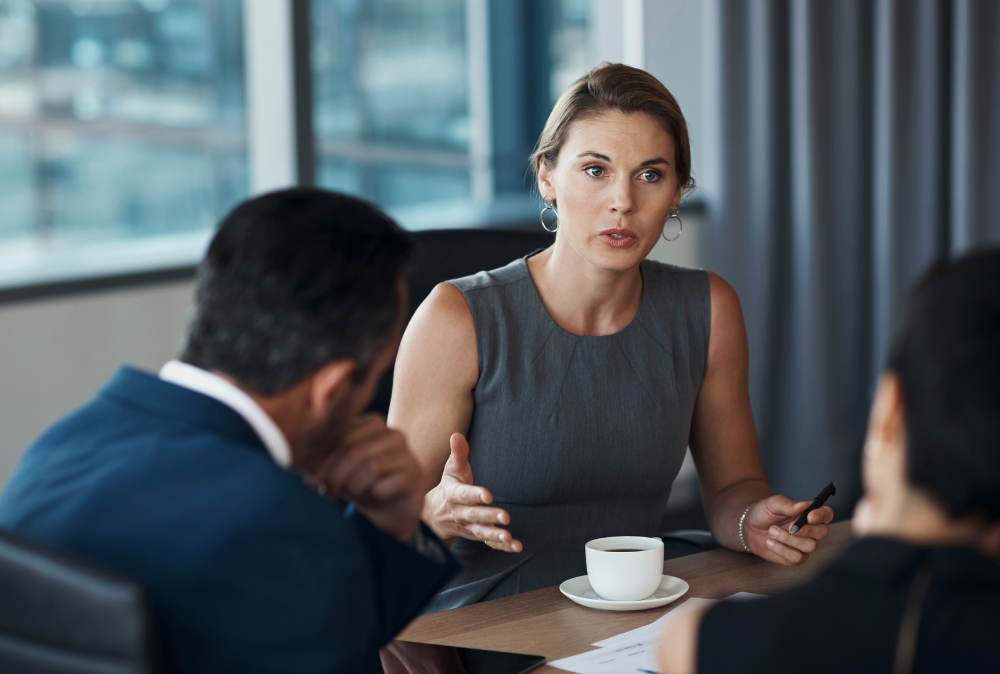 Women in formal dress talking to collogues in ethics conference