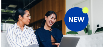 women smiling at a laptop